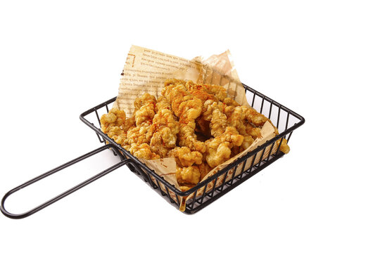 Crispy Fried Pork Cracklings in Wire Basket on White Background