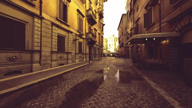 dawn light empty urban alley with soft glow, wet cobbles catching first rays, silent facades and long leading lines, cinematic travel mood for editorial use