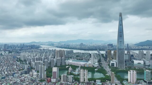 Aerial Drone View of Jamsil Station Cityscape, Lotte World Tower, and Han River Landscape in Seoul, South Korea