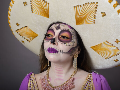 Elegant Woman Wearing Large Mexican Sombrero and Day of the Dead Makeup Portrait