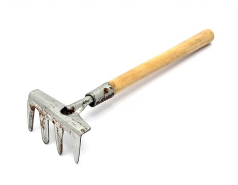 Vintage hand rake with a wooden handle isolated on a white background studio shot