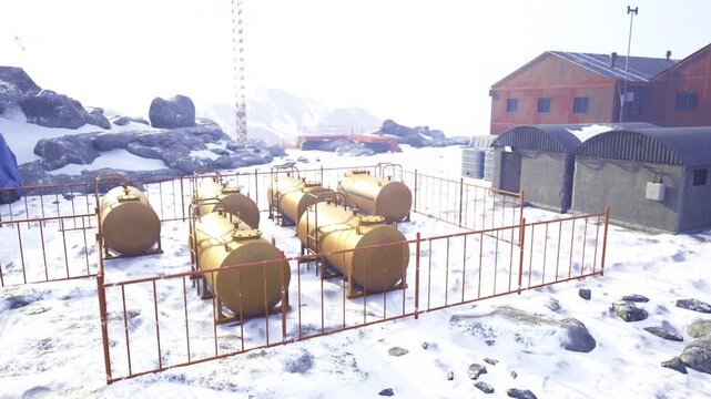 Snowcovered fuel tanks in remote Arctic camp, fenced storage compound under pale sunrise, industrial buildings and maintenance pathways dusted with snow,