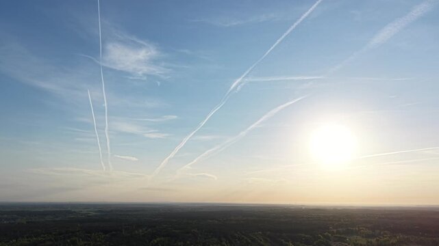 Peaceful scene of a colorful sky and jet paths
