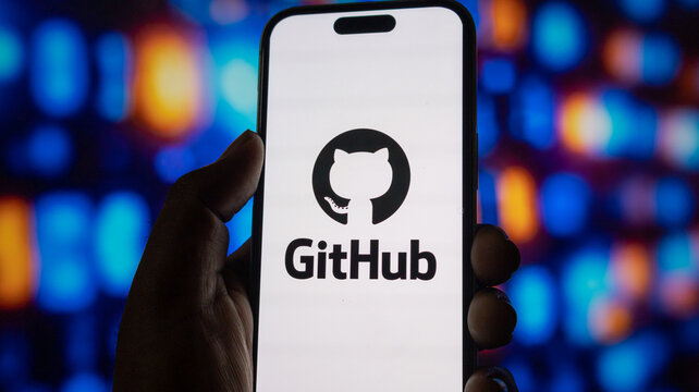 Hand holding smartphone showing github icon on display with glowing abstract background light effect.