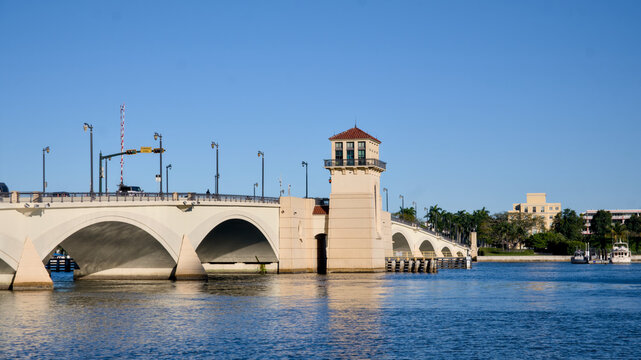A multi arch stone bridge crosses a coastal waterway