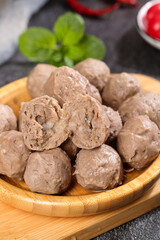 Fototapeta premium Handmade Chaoshan Beef Tendon Meatballs Traditional Chinese Food in Wooden Bowl Studio Shot