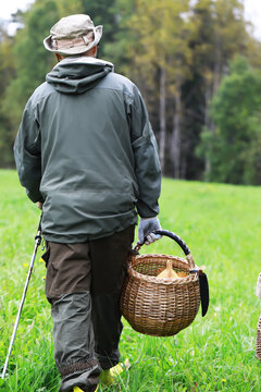 Mushroom Picking Adventure: Man in Forest with Basket and Hiking Gear