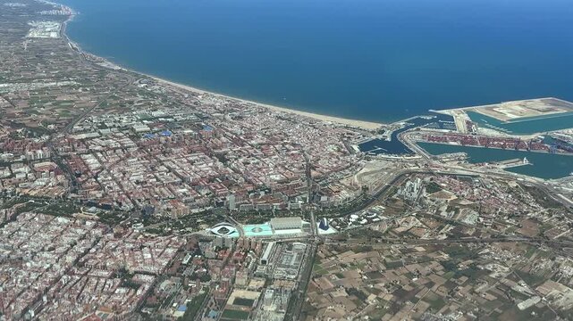 An aerial cockpit window view of Valencia city and coast, taken at 2000m high from an airplane , with a view of the city center and coast.