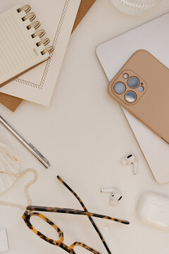 Flat Lay Workspace Frame With Smartphone, Laptop, Tortoiseshell Glasses, And Central Copy Space