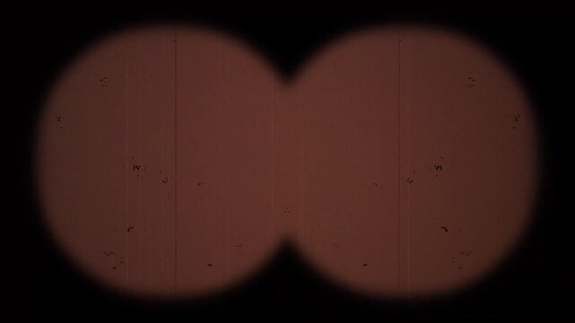 Retro binocular view through 8mm film overlay featuring vintage old movie frame flicker with film grain dust scratches analog cinema nostalgic texture 4k video