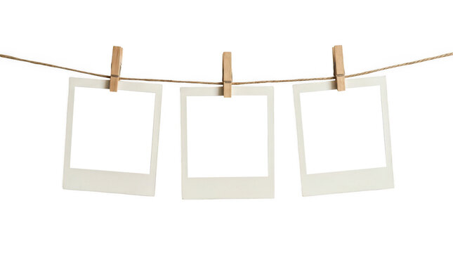 Three blank polaroid photo frames hanging on a rope isolated on transparent background