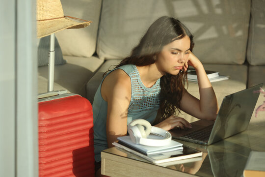 Bored and overwhelmed student studying on vacation