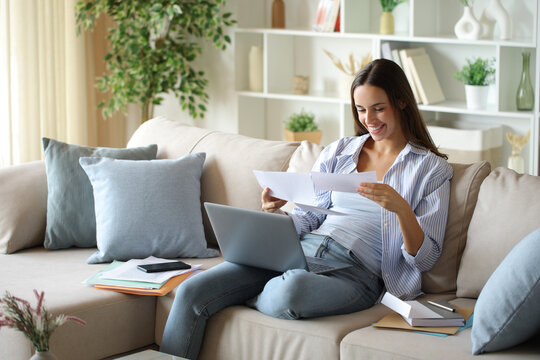 Happy teleworker is reading letter working at home