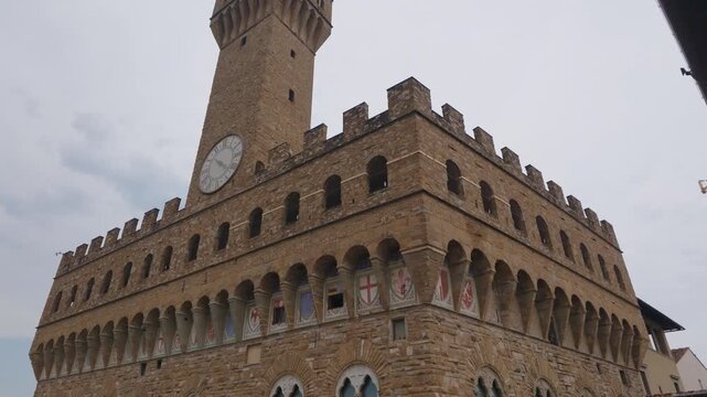 Low Angle View of Palazzo Vecchio Clock Tower Against Overcast Sky in Florence Italy