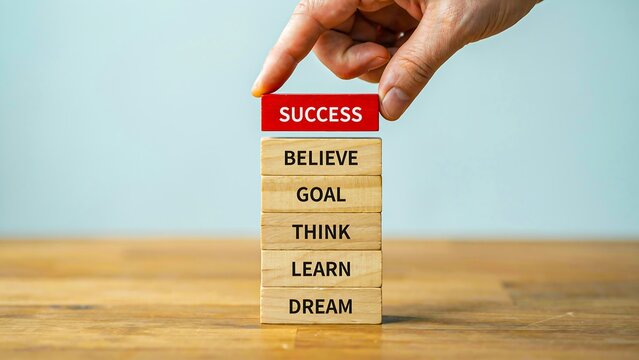 Hand placing wooden block with success mindset and personal development concept