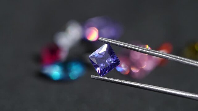 Exquisite pear-shaped diamond with swaying slightly with sparkles brilliantly in tweezers, showcasing rare luxury and investment value