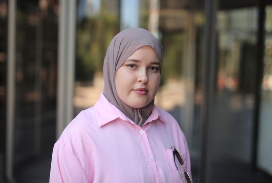 Confident young woman in hijab standing outdoors
