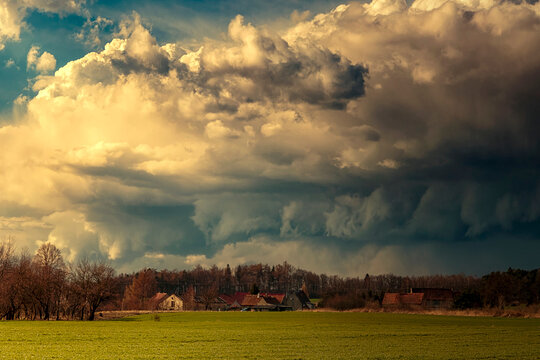 Dramatic storm clouds looming over rural village