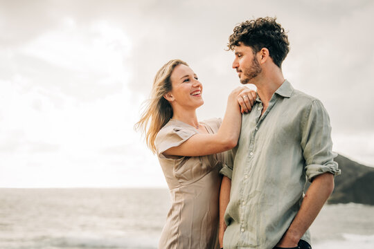 Happy young couple shares a loving glance outdoors