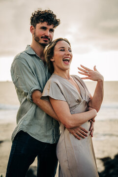 Joyful woman shows off engagement ring with fianc&eacute;