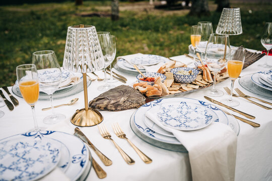 Stylish alfresco dining table with appetizers and mimosas