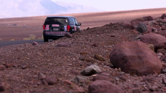 close up of dirt and soft focus runners in the desert