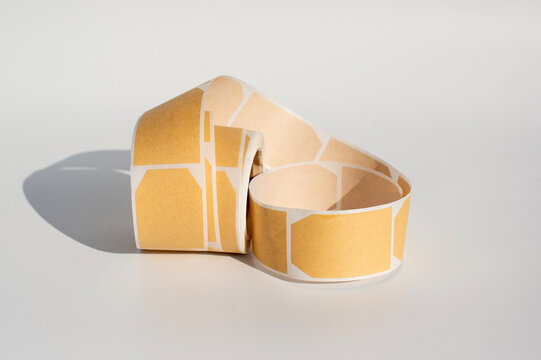 Hexagonal stickers roll on white background with shadows