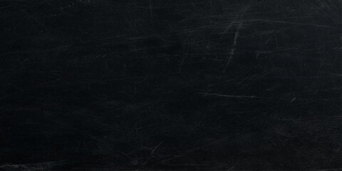 Fototapeta premium black wall texture with rough concrete surface and scratches or dark grunge black wall texture with cracked concrete surface and old stained grunge effect.