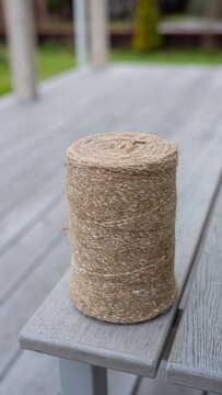 Natural jute twine roll on outdoor wooden bench