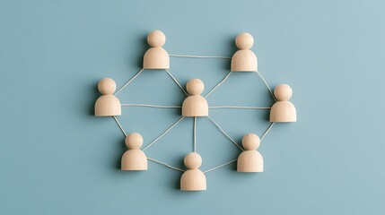 Obraz premium Wooden figures connected by lines on blue. Conceptual model representing business networking and teamwork.