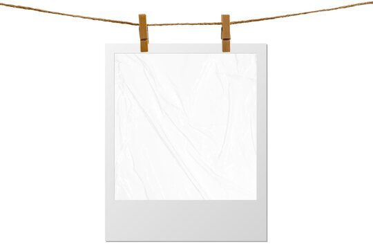 Blank photo frame hanging on a rope with a wooden clothespin. Isolated transparent PNG mockup.