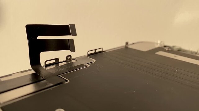 Smartphone display repair. A chip of flexible ribbon cable from a mobile phone display. A touch-screen controller. Flexible ribbon cable close-up. The display loop. 4k