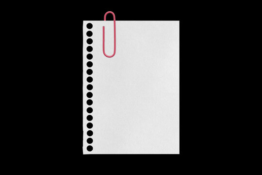 white sheet torn from a notebook on a black background with a colored paper clip