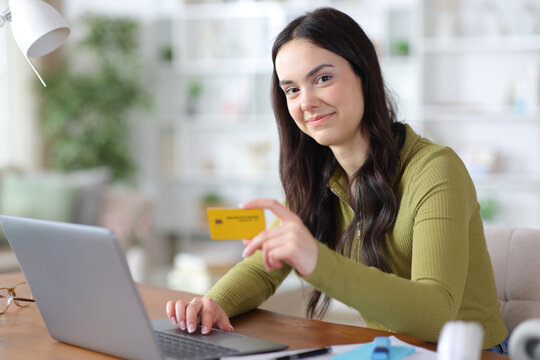 Satisfied student looking at you paying online with credit card