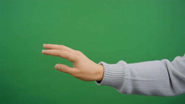 Clean human hand executing a horizontal swipe left gesture against a green screen for mobile app UI demos, e-commerce navigation, and digital marketing motion graphics overlays.