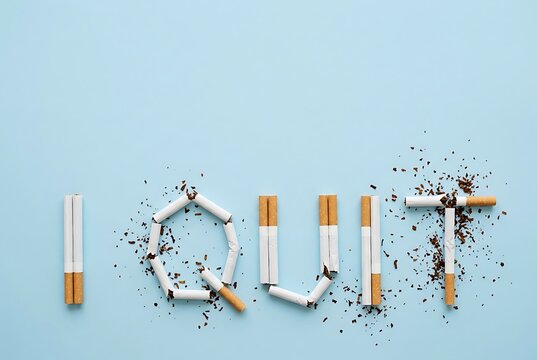 Cigarettes arranged to spell 'I QUIT' on blue background. Health and Wellness concept.