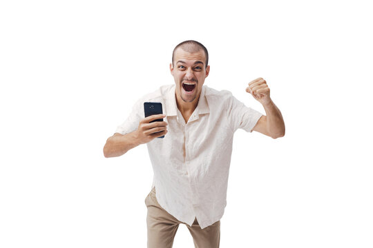 Excited Young Man Holding Smartphone and Raising Fist in Victory