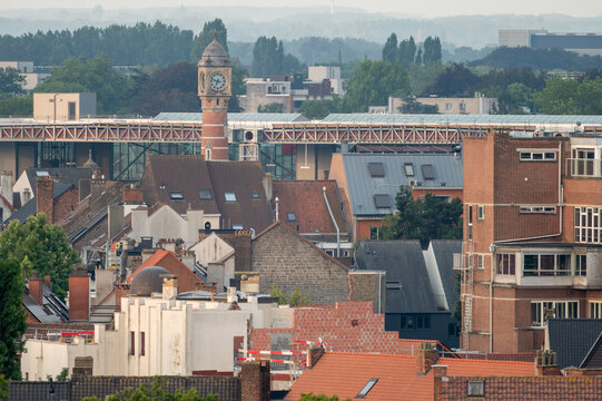 The red rooftops of Ghent stretch toward a historic tower in the morning light in Belgium a view over the old Flemish city.