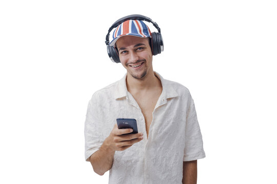 Happy Young Man with Headphones and British Flag Cap Holding Smartphone on Yellow Background