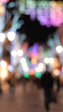 A Nighttime Scene Filled with Glowing Lights and Eager Passersby Blurred in Motion, Capturing the Essence of Festivity and Ambiance in an Urban Setting