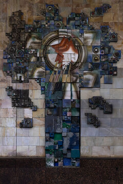 Soviet-era ceramic relief mural with red star in Tashkent Gafur Gulom metro station. Abstract glazed tile artwork on marble wall illustrating communist symbolism in Uzbekistan underground transit.
