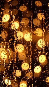 A Beautiful Display of Softly Glowing Yellow Circles Behind a Wet Window Pane, Highlighting a Soft and Dreamy Atmosphere with Raindrops Distorting the Light