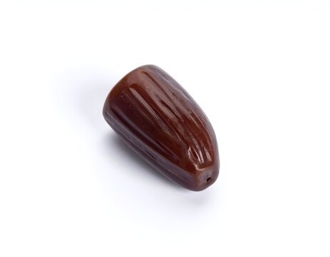 Single organic dried date fruit isolated on white background studio photo