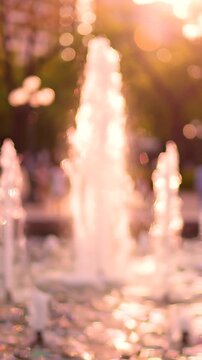 A Dreamy Sunset Reflection: Soothing Water Fountain Sprays in a Lush Park, Creating a Tranquil Atmosphere Filled with Soft Hues and Gentle Mist
