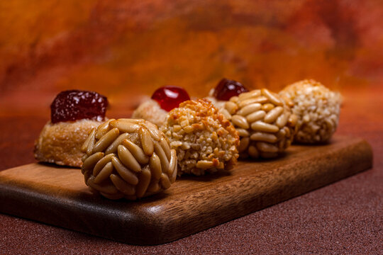 Traditional panellets resting on wooden board for castanyada celebration