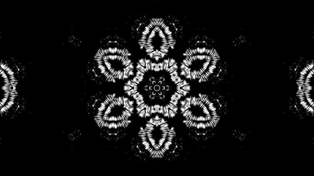 Black background with intricate white mandala pattern. Symmetry dominates the design