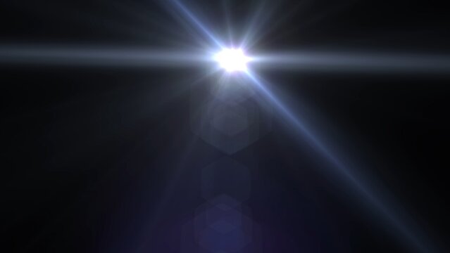 Bright light shines against pure black background. Lens flares glow with soft blue and white tones