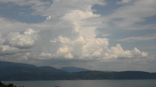 Spectacular time lapse of a developing storm cloud over the mountains at the eastern shore of Lake Garda, Italy.