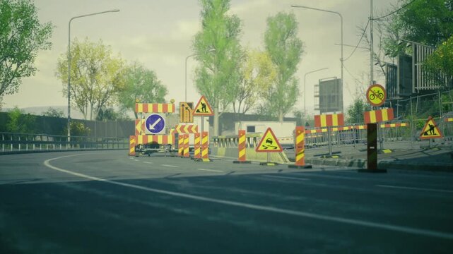 Bridge repair traffic control with warning signs and lane barriers channeling vehicles away from work zone distant greenery and crisp light set calm mood.