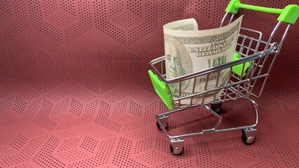 Mini shopping cart carrying a folded hundred-dollar note, illustrating consumer spending and financial purchasing power © MR HEPPY